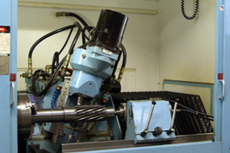 Gear hobbing machine cutting teeth for custom spur and helical gears